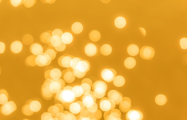 Yellow bokeh background texture. Golden blurred bright glare of light texture