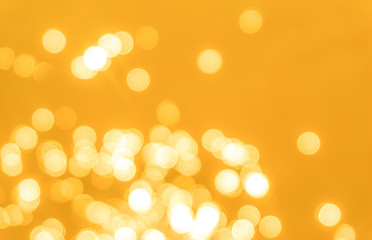 Yellow bokeh background texture. Golden blurred bright glare of light texture