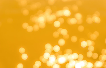 Yellow bokeh background texture. Golden blurred bright glare of light texture