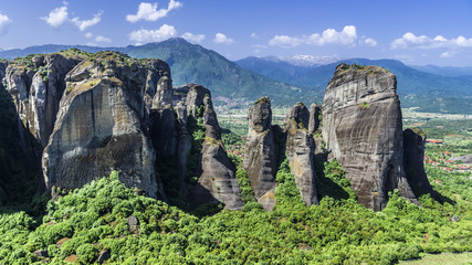 Green forest at the foot of cliffs