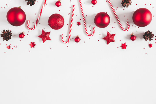 Christmas composition. Border made of red decorations on white background. Christmas, winter, new year concept. Flat lay, top view, copy space
