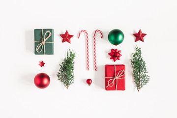 Christmas composition. Gifts, fir tree branches, red decorations on white background. Christmas,...
