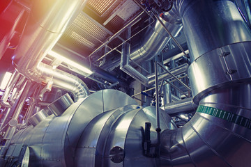 Equipment, cables and piping as found inside of a modern industrial power plant