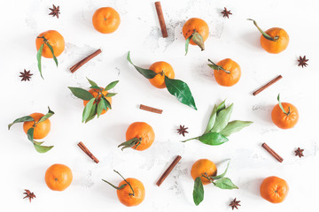 Christmas composition. Tangerines, cinnamon sticks, anise stars on white background. Christmas, winter concept. Flat lay, top view