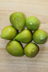 Green figs on wooden desk