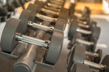 Fototapeta premium Rows of dumbbells in the gym with hign contrast and monochrome color tone