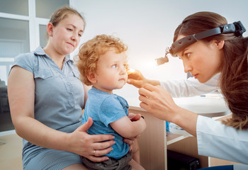 Otolaryngologist examines little boy. Medical equipment