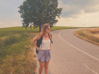 Young girl walking in suburb countryside road.