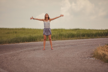 Fototapeta premium Girl enjoying on a empty suburb road.