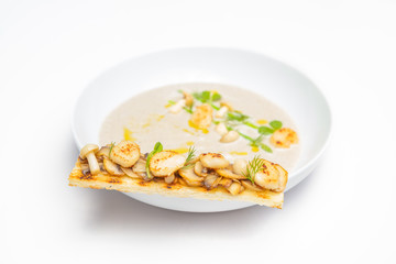 Cream mushroom soup with scallops and some herbs.