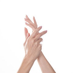 Young woman touching her hand and feeling moisturizing effect of cream on white background.
