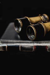Ancient binoculars lie on book
