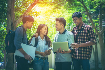 A group of Asian student was walking on the road within the University. They talk to smile happily to walk together.