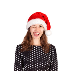 Portrait of joyful pretty woman in dress. emotional girl in santa claus christmas hat isolated on white background. holiday concept