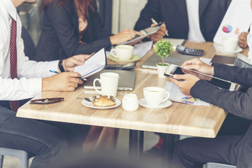Collaboration Marketing Team Collaborate in office meeting. Group of people using smartphone working Sales Team. Marketing communications strategy in business office. Banner with copy space.
