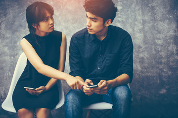 Asian couples are having problems. Husband and wife are pointing at the censure of him by showing...