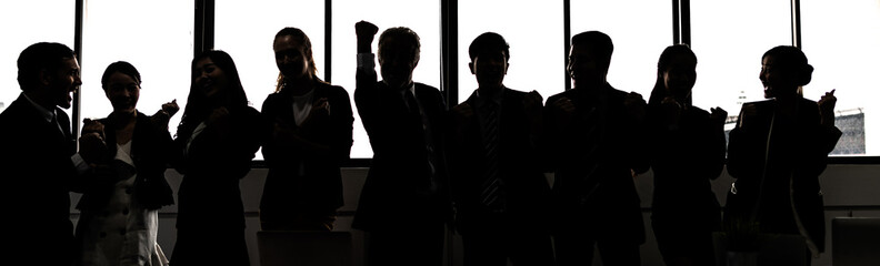 Silhouette of Business People Celebrating In Board Room