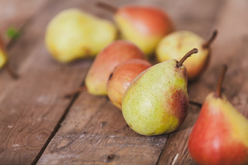 Several ripe pears lie on boards