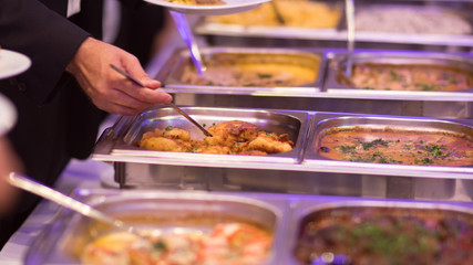 People group catering buffet food indoor in luxury restaurant with meat colorful fruits and vegetables