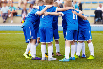 Young boys sports team on stadium. Football players in sportswear motivating before the match. Youth soccer tournament game for kids