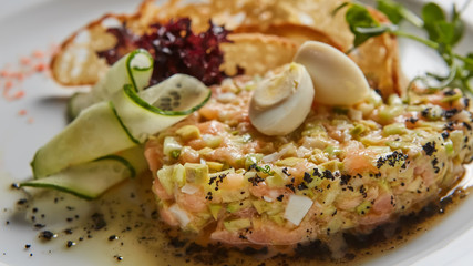 The salmon tartare with avocado. Shallow dof