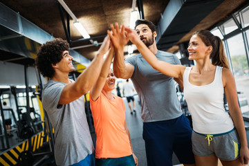 Portrait of cheerful fitness team in gym