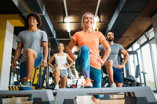 Group of young people doing exercises in gym