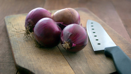 Fresh Raw Red Onions, Knife On A Rustic Wooden Cutting Board. Food Preparation, Cooking Concept.