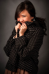 Obraz premium Fashion portrait in studio of beautiful young asian smiling woman feeling happy in casual dress over dark background