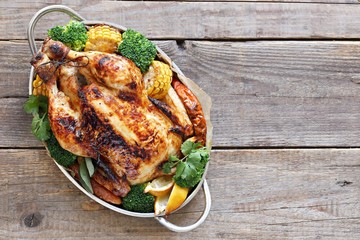 Thanksgiving day food. Festive family dinner table with roasted chicken or turkey and various of vegetables. 