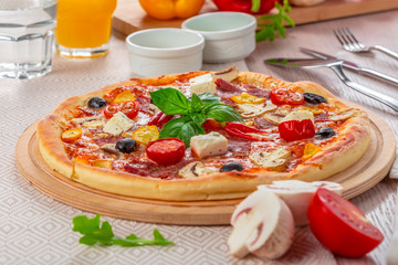 Pizza with Mozzarella, Ham, Cherry Tomatoes, Black Olives