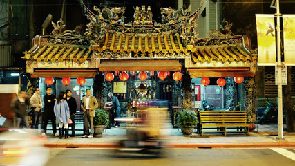 Naklejka premium Young people waiting at Taipei Taiwan old temple during buzzing night life