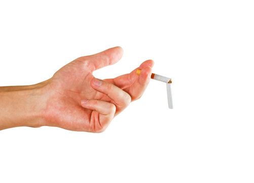 Hand holding a broken cigarette. Close up. Isolated on white background
