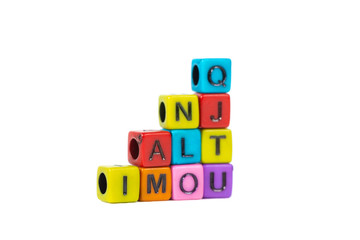 Pile of letter bead or beads with alphabet on white background.