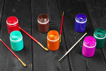 paint bottels on rustic wooden background