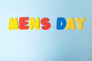 International men's day background with colorful mugs with a mustache on a blue background.