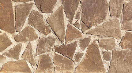 the texture of the finishing stone on the wall. Artificial stone.