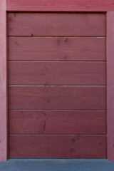 A wooden texture made of dark burgundy color horizontal boards.