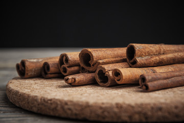 Cinnamon sticks on wooden background.