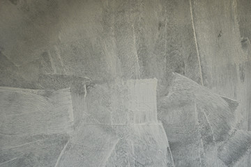 Grey surface of grunge concrete wall just painted with white primer paint as abstract textured...