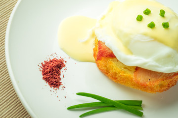 Breakfast is Eggs Benedict - toasted English muffins, bacon, ham, poached eggs, herbs and delicious buttery hollandaise sauce.