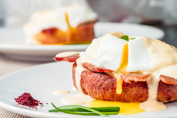 Breakfast is Eggs Benedict - toasted English muffins, bacon, ham, poached eggs, herbs and delicious buttery hollandaise sauce.