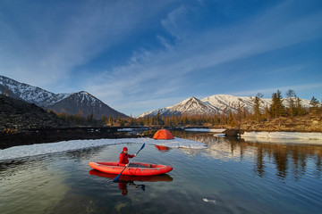 Man paddling kayak in mountain lake. Freedom.