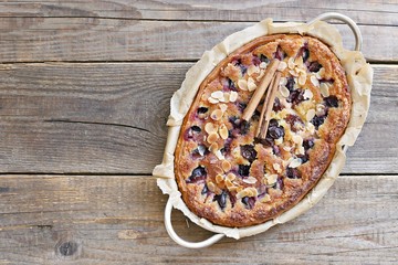 Plum cake. Spicy cake with plums, almond filling and cinnamon. Overhead view