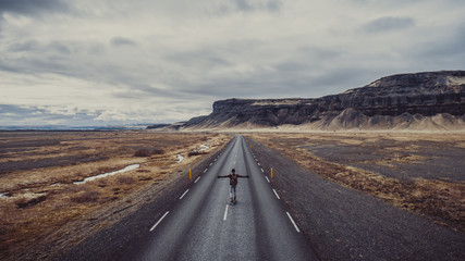 Man exploring beautiful destination with his longboard