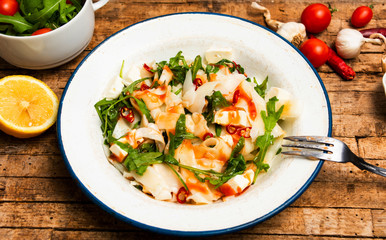 Homemade pasta with arugula on a plate