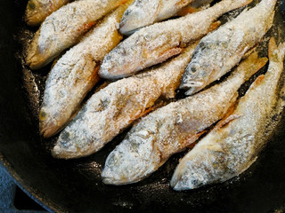 Fried perch fish carcass in breading flour.