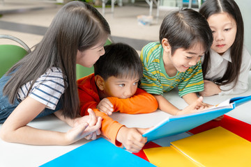 Fototapeta na wymiar Asian Little Children Reading Book Cheerful