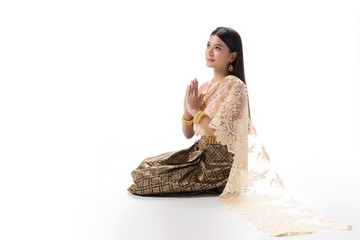 Cute girl in Thai national dress. Looks attractive and so elegant. Thai dress made from greatest Thai silk. Accessories made from gems stone, pearls and Gold. Her eyes looks charm like a spell.Cute gi