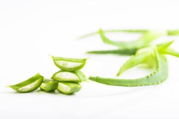 Cut Aloe Vera leaves on white background.